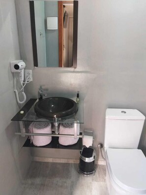 Shower, hair dryer, towels, toilet paper