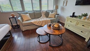 A living room with a sofa, a coffee table, a side table, and a cabinet. - 30-A Getaway near Seaside, FL --Great for Snowbirds, couples, or small families (Santa Rosa Beach)