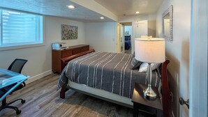 A bedroom with a bed, desk, chair, dresser, lamp, and artwork. - Extended Ski/Work/Visit secluded Cul-da-sac cutie (Salt Lake City)