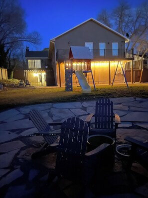 A house with a patio area featuring Adirondack chairs and a fire pit. - Extended Ski/Work/Visit secluded Cul-da-sac cutie (Salt Lake City)