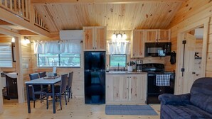 L'intérieur d'une cabine comprenant un coin repas, une cuisine et un espace salon.