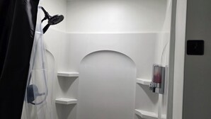 A bathroom with a shower, a toilet, and a sink. - Quiet cheerful condo in the heart of OTR! (Cincinnati)