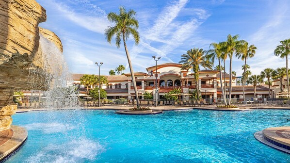 A hotel with a large pool, palm trees, and a waterfall feature. - Great resort with great location near Sea World and Outlets in fabulous Orlando. (Orlando)