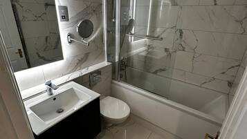 Shower, hair dryer, towels, toilet paper
