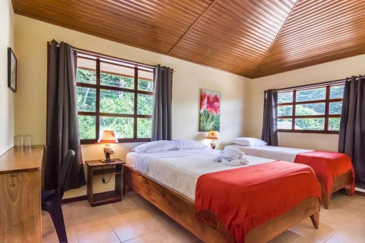A room with two beds, a desk, and a chair.