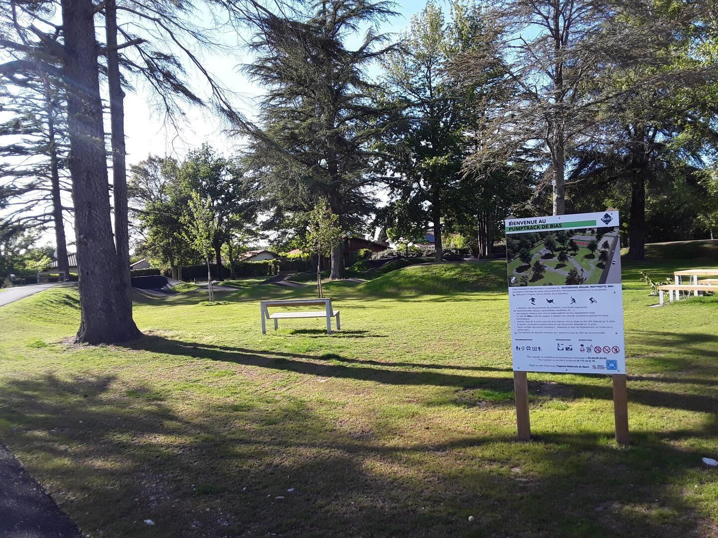 Een park met een bord waarop staat 'BIENVENUE AU PUMPTRACK DE BIAS'.