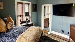 A bedroom with a bed, a ceiling fan, a TV mounted on the wall, and a window with blinds. - Superb 4-bedroom historical house in Fredericktown (Fredericktown)