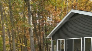 A deck with outdoor seating and a small building with windows. - Looking for a perfect getaway? (Stanwood)