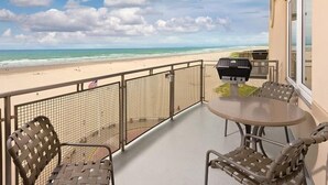 A balcony with a view of the beach, a grill, and outdoor seating. - Seaside Beachfront, Spring Break, beautiful, welcoming Condo. STEPS TO THE BEACH (Seaside)