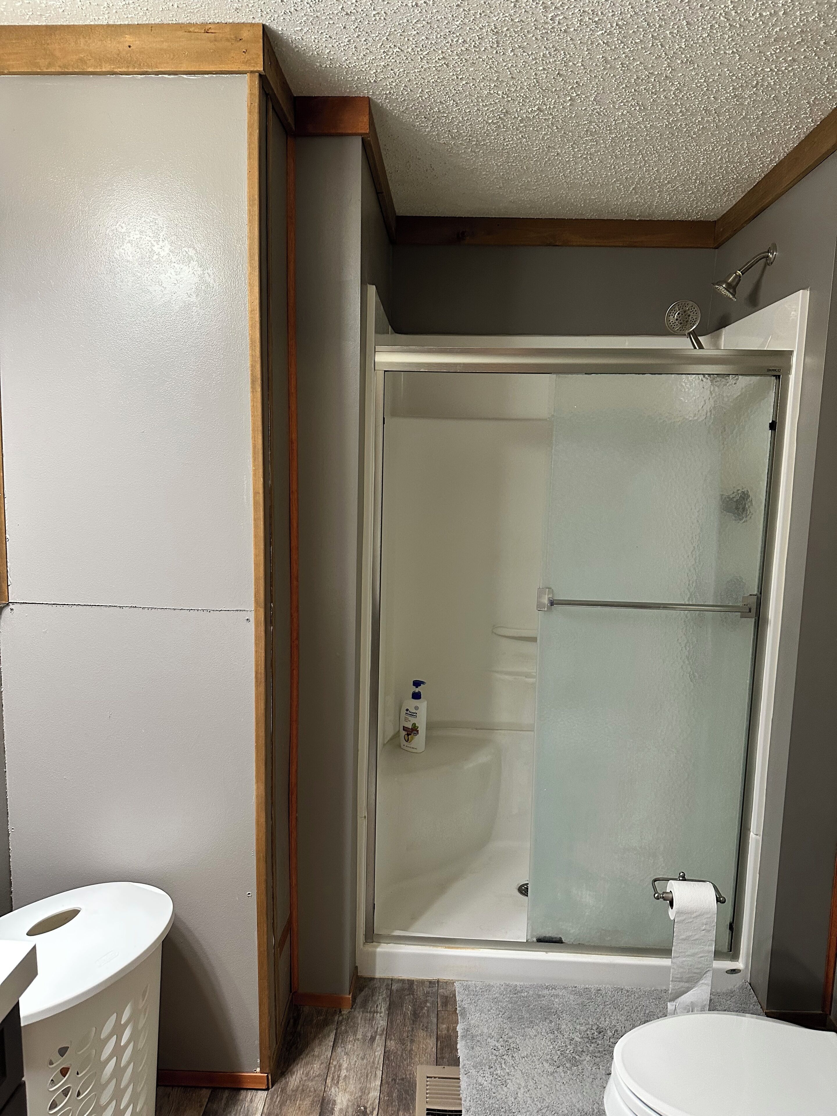 A bathroom with a shower, toilet, and sink.