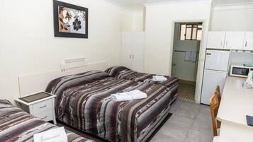 Desk, laptop workspace, blackout drapes, iron/ironing board