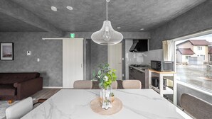 A modern kitchen with a microwave, stove, and sink. - SASAMEYUKI (Furano)