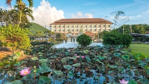 A hotel with a large building, a lotus pond, and surrounding greenery. - Swan Lake Hotel Sattahip (Sattahip)
