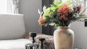 A table with a vase of flowers, two glass cups, and a decorative tray. - THE SHIMMER FURANO (Furano)