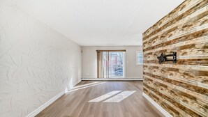 A modern interior with a wooden floor, white textured walls, and a wooden accent wall. - Chinook II.
Pet Friendly 
 Nutrien ,CGC Inc Wheatland Plant, De Havilland. (Strathmore)