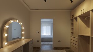 A bedroom with a vanity, mirror, and walk-in closet. - Al-Sawah  Upper Duplex 3BR – Eastown Sodic (New Cairo)