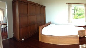 A bedroom with a wooden bed, a wardrobe, a dresser, and a mirror. - Room-nakara Samui-2 Bedrooms Ocean View (Koh Samui)