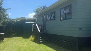A mobile home with a small porch and a single window.