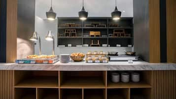 A buffet setup with various food items, a sink, and overhead lighting.