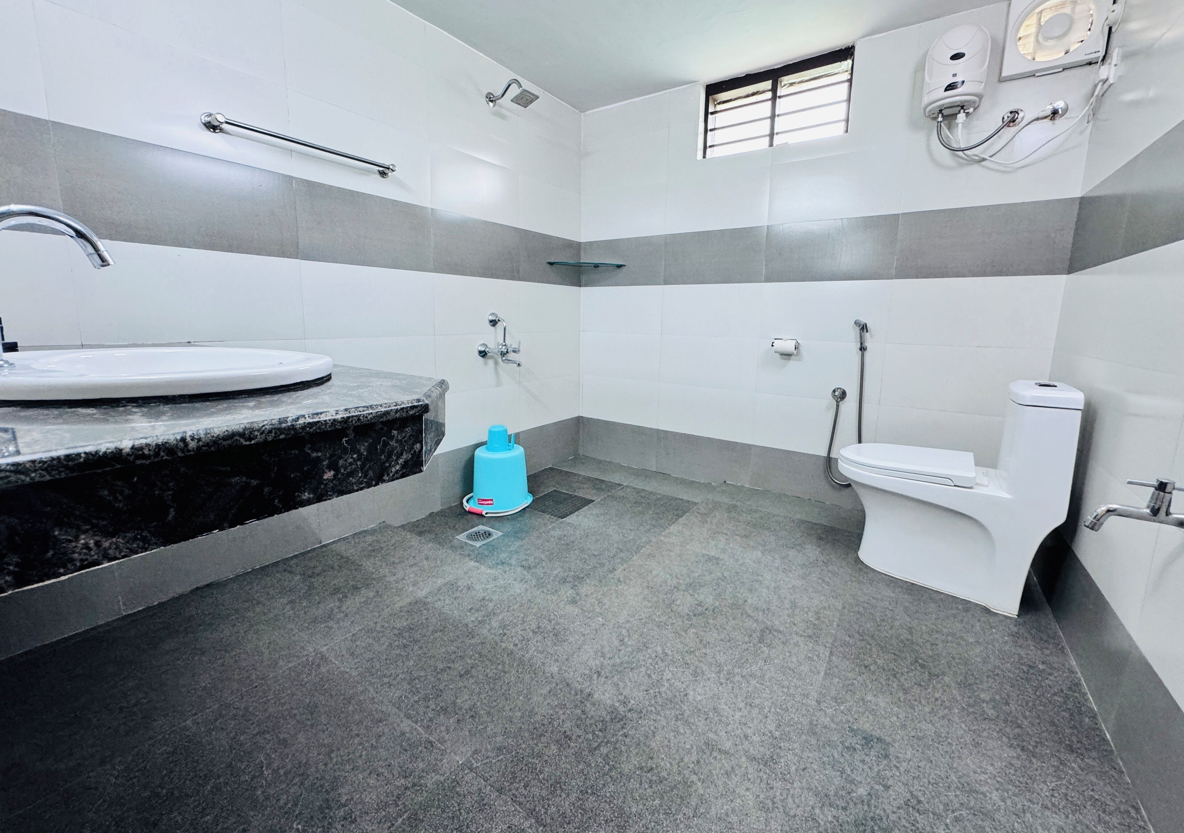 A bathroom with a sink, toilet, and shower.