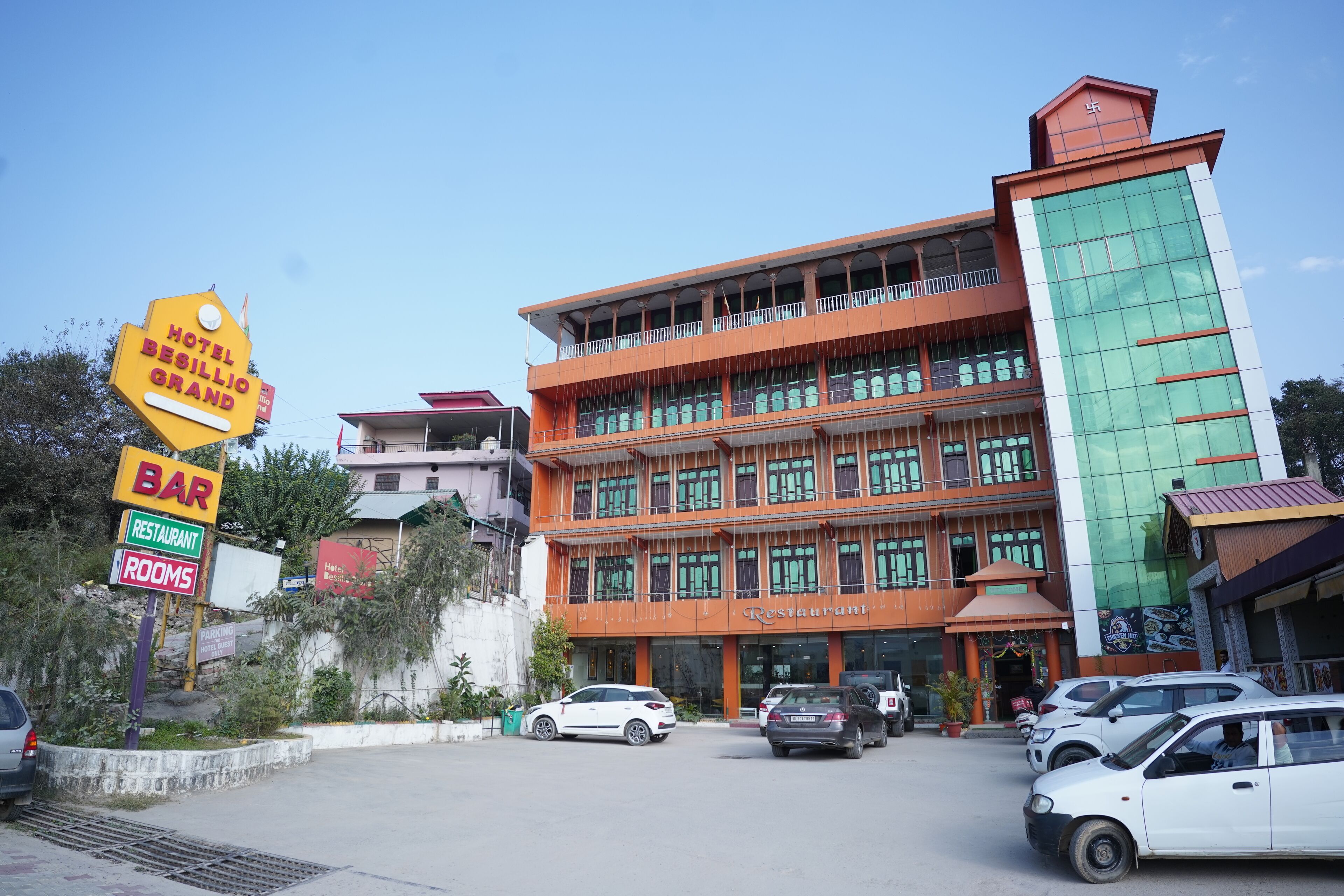A hotel with multiple floors, a bar, restaurant, and rooms.