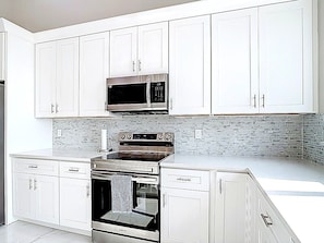 Coffee/tea maker, fridge, microwave, oven