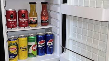 An open refrigerator with beverages and condiments.