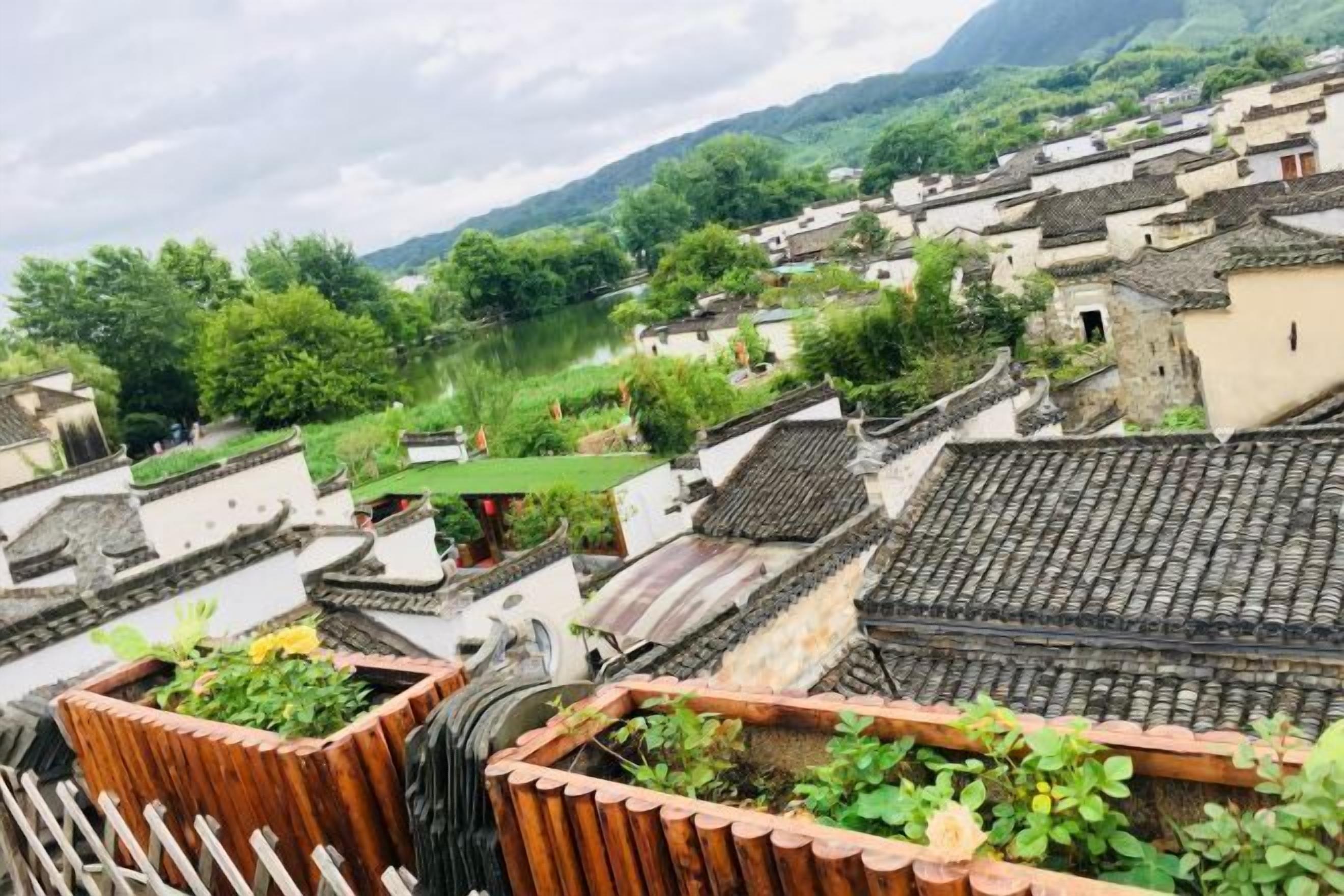 Un village traditionnel avec des maisons construites en terrasses et une rivière.