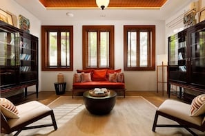 Una sala de estar con sofá, sillones, una mesa de centro y chimenea.