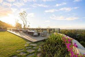 A deck with outdoor furniture, a view of the landscape, and a tree. - The Tulou Bali by Nakula (Bali)