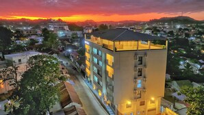 A multi-story hotel with a modern design, featuring balconies and large windows. - ZEN Hôtel (Nosy Be)