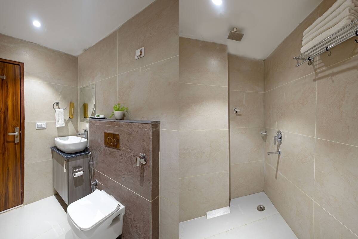 Un bany modern amb un lavabo, vàter i dutxa.