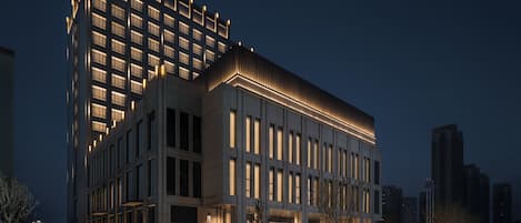 A modern building with a prominent corner section and a flat facade.