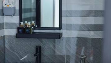 A bathroom with a white sink, black faucet, and a mirror above.
