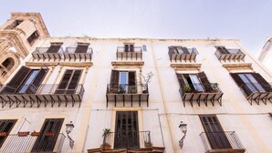 A multi-story building with balconies, windows, and a corner tower. - Palazzo del Bono suites (Palermo)
