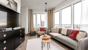 Deluxe Suite, Kitchen, City View | Living room | 55-inch flat-screen TV with cable channels