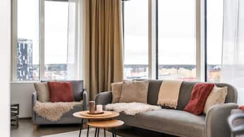 Deluxe Suite, Kitchen, City View | Living room | 55-inch flat-screen TV with cable channels