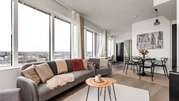 Deluxe Suite, Kitchen, City View | Living room | 55-inch flat-screen TV with cable channels