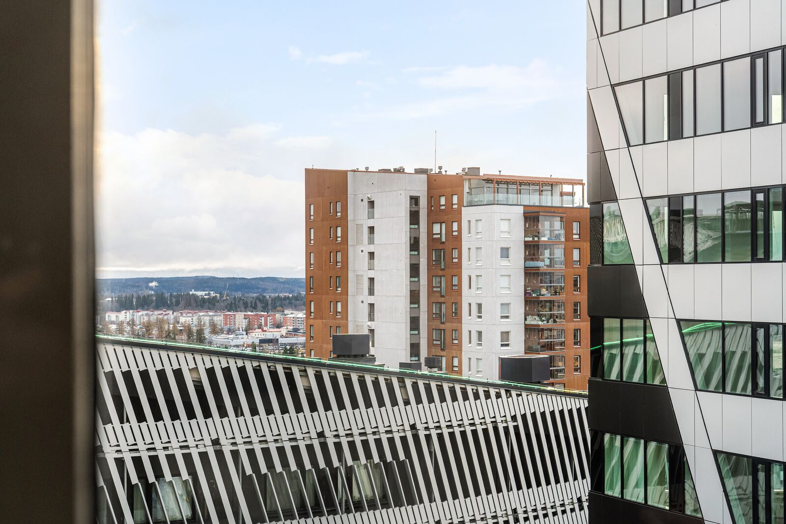 Een modern gebouw met een geometrisch gevelontwerp en grote ramen.
