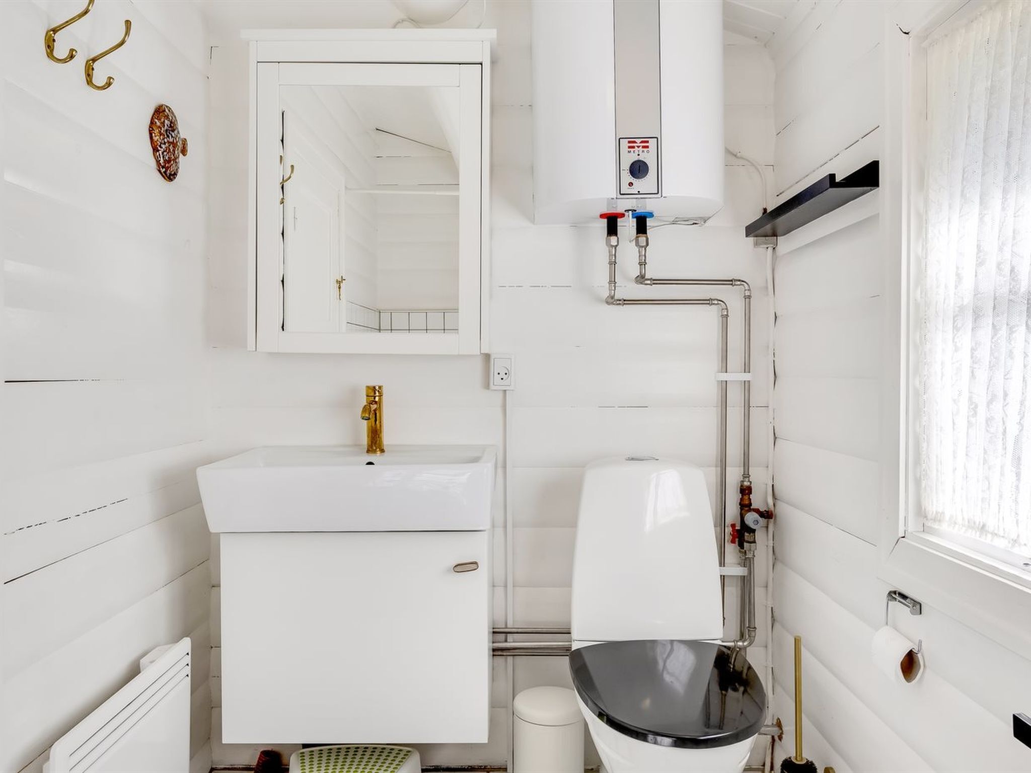 A modern bathroom with a white sink, toilet, and vanity.
