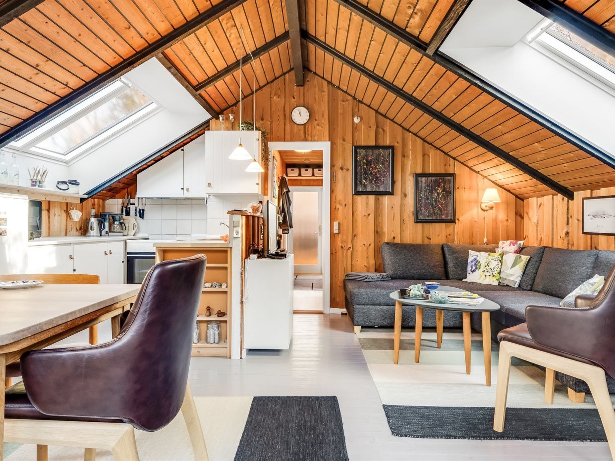 A loft-style living space with a kitchen, dining area, and seating area.