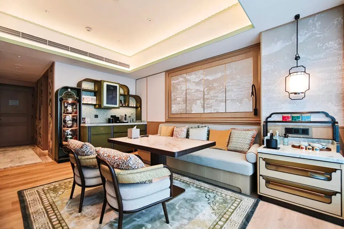 A modern interior with a dining area, sofa, and kitchen counter.