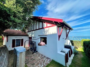 A white building with a red roof and a stone pathway leading to a door. - Newly renovated + fantastic bay view A0022 (Lège-Cap-Ferret)