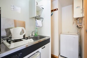 A compact kitchenette with a coffee maker, a small sink, and a refrigerator. - Shinjuku 202 for 2 peoples, private toilet + small kitchen (中野區)