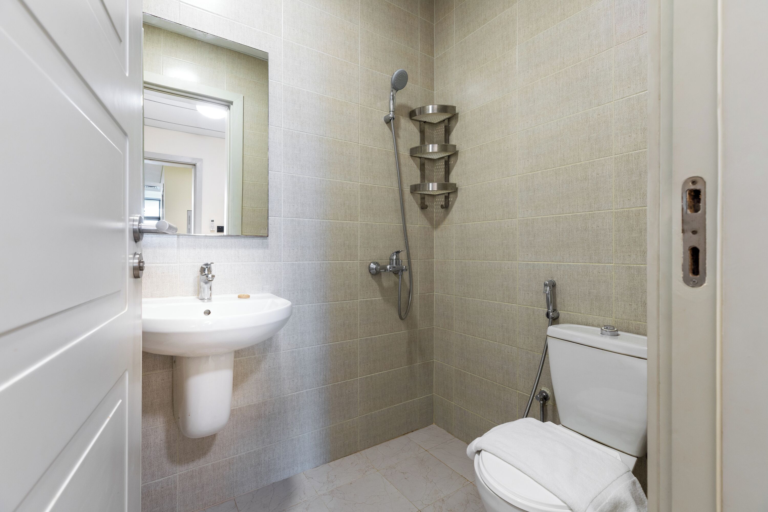 A bathroom with a sink, toilet, and shower.