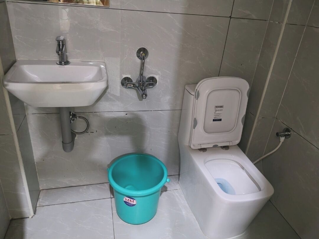 A bathroom with a sink, a bidet, and a toilet.