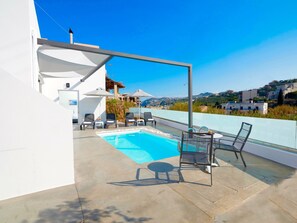 A rooftop pool area with lounge chairs and umbrellas, overlooking a scenic hillside. - Villa Paradiso 1 With Private Pool (Malevizi)