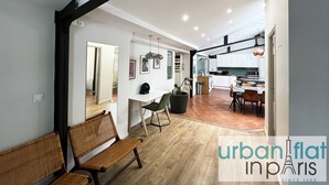 A modern interior with a dining area, kitchen, and a bench.