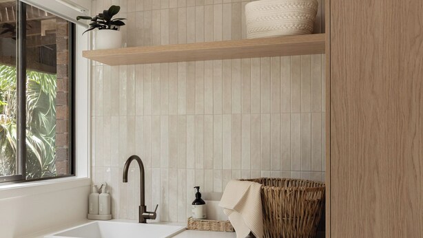 A compact laundry room with a washing machine, a sink, and a window. - Costal Comfort (Nelson Bay)