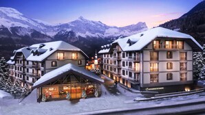 A hotel with multiple floors, balconies, and a ski lift in the background. - Apartment in Saint-gervais Near Mont Blanc (Saint-Gervais-les-Bains)
